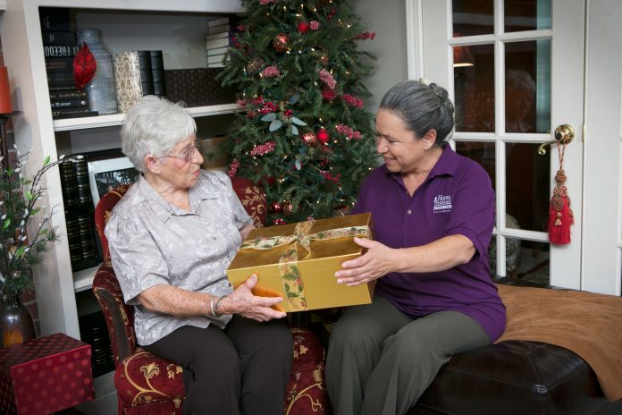 BASTAS-Female-Caregiver-and-Female-Senior-with-Christmas-Gift-2