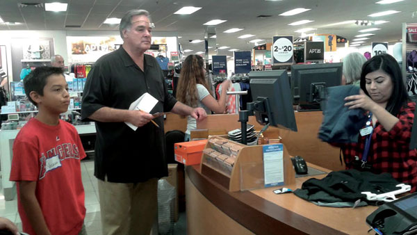  courtesy photo  Redlands Elks Lodge member Court Inman checks out with Nic Romero at Kohl’s in Redlands on July 16. The Elks used a grant to fund a back-to-school shopping spree for more than 20 kids from Boys & Girls Clubs of Greater Redlands-Riverside.