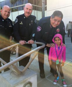 courtesy photo/ rialto police dept. From left: Rialto police Cpt. William Wilson, Cpt. Andy Karol and Chief Randy De Anda visit with Loma Linda Children’s Hospital patient Chasity Martinez, 6.