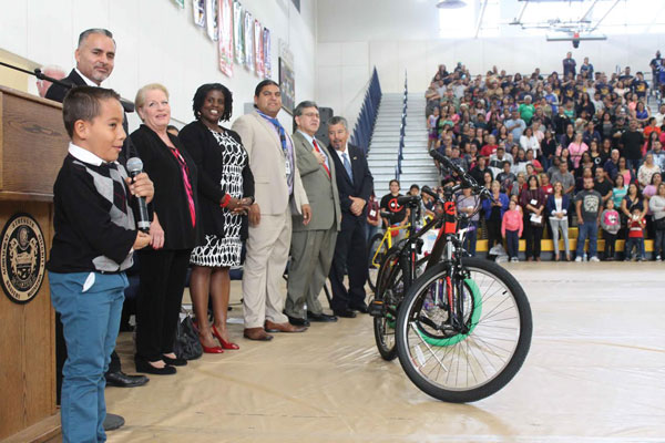 courtesy photo/ rialto unified school district Garcia Elementary School student, Samuel Llamas recites the Pledge of Allegiance as RUSD Board members and thousands of parents watch on.  