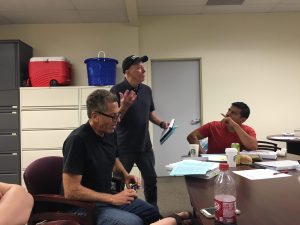 Courtesy Photo: Veteran Jerry Donovan Smith engaging with CSUSB student and U.S. Marine Juan Hernandez during a Dialogues on the Experience of War meeting back in July, right. Left, San Bernardino Valley College English Professor Joe Notarangelo browses the text