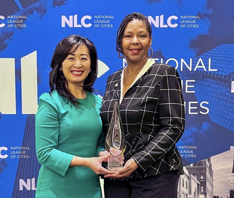 Two community leaders accepting an award.