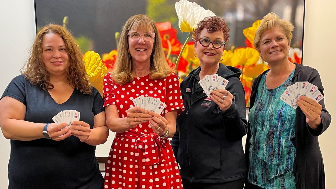 A group of women holding gas gift cards at Loma Linda University Health