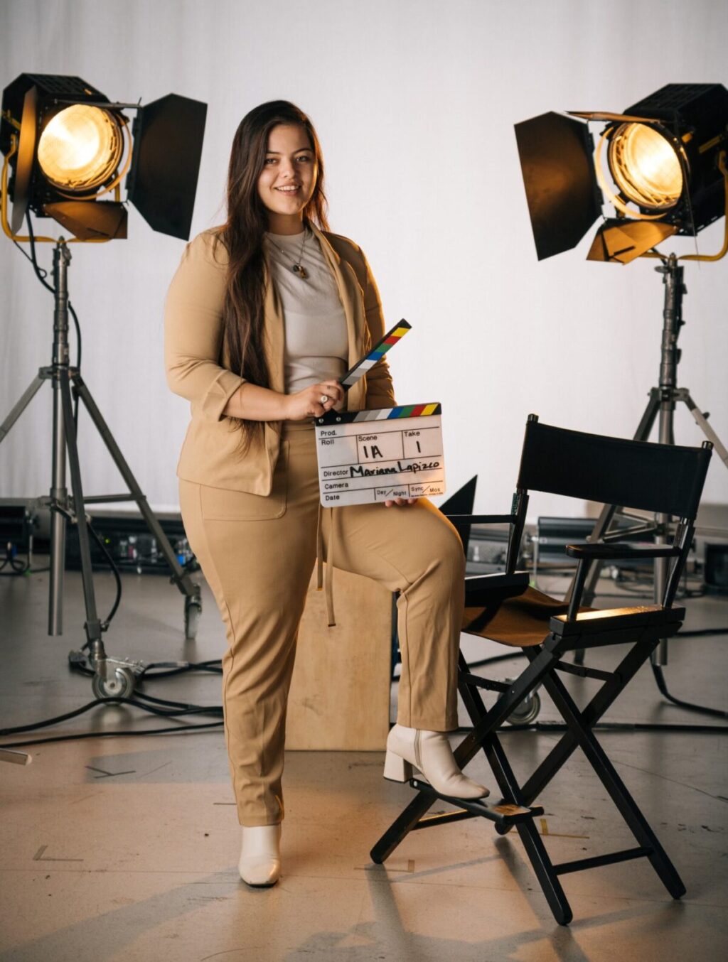 A media student intern holding holding a slate