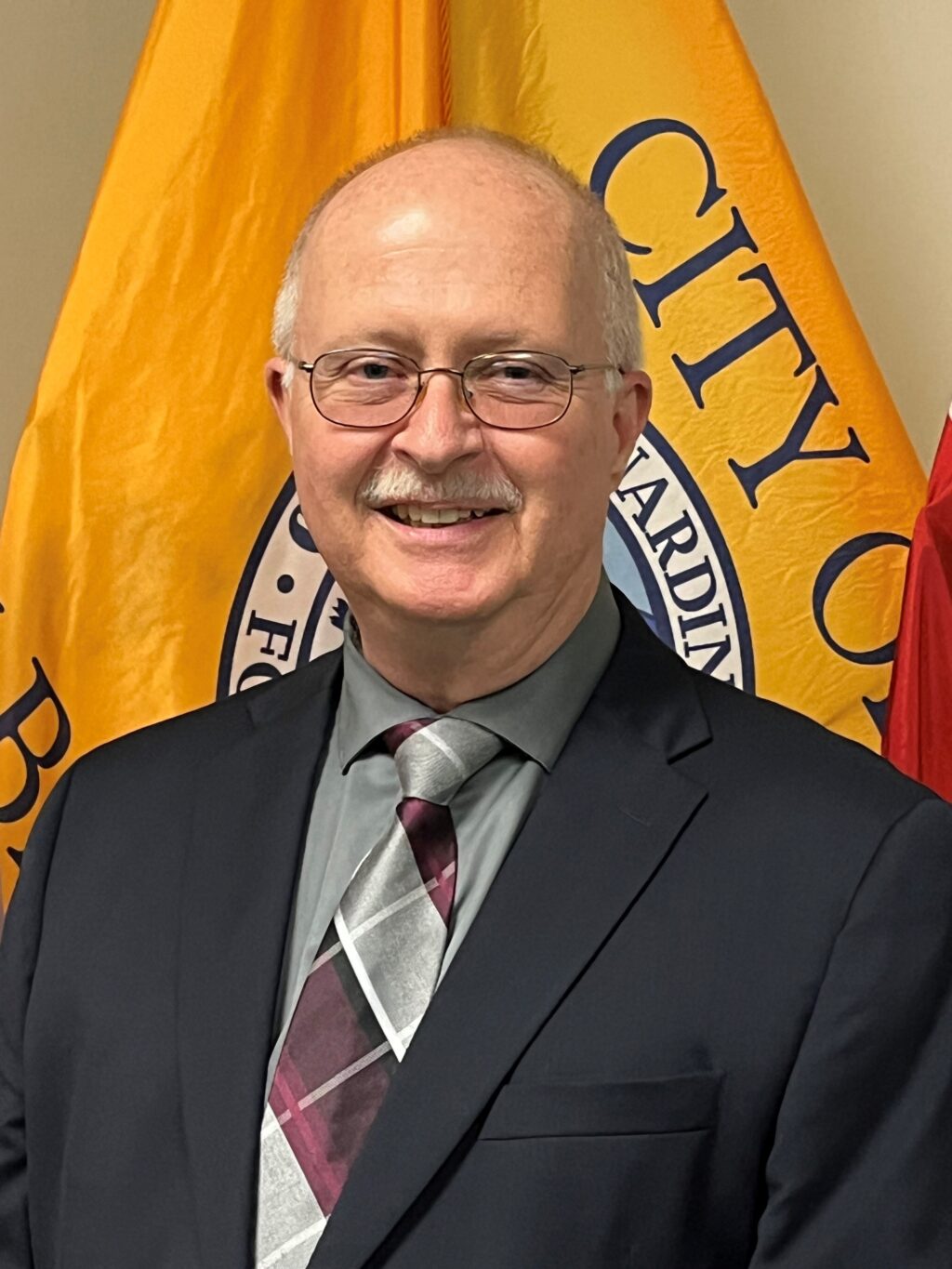 A professional headshot of an employee that a city just hired.