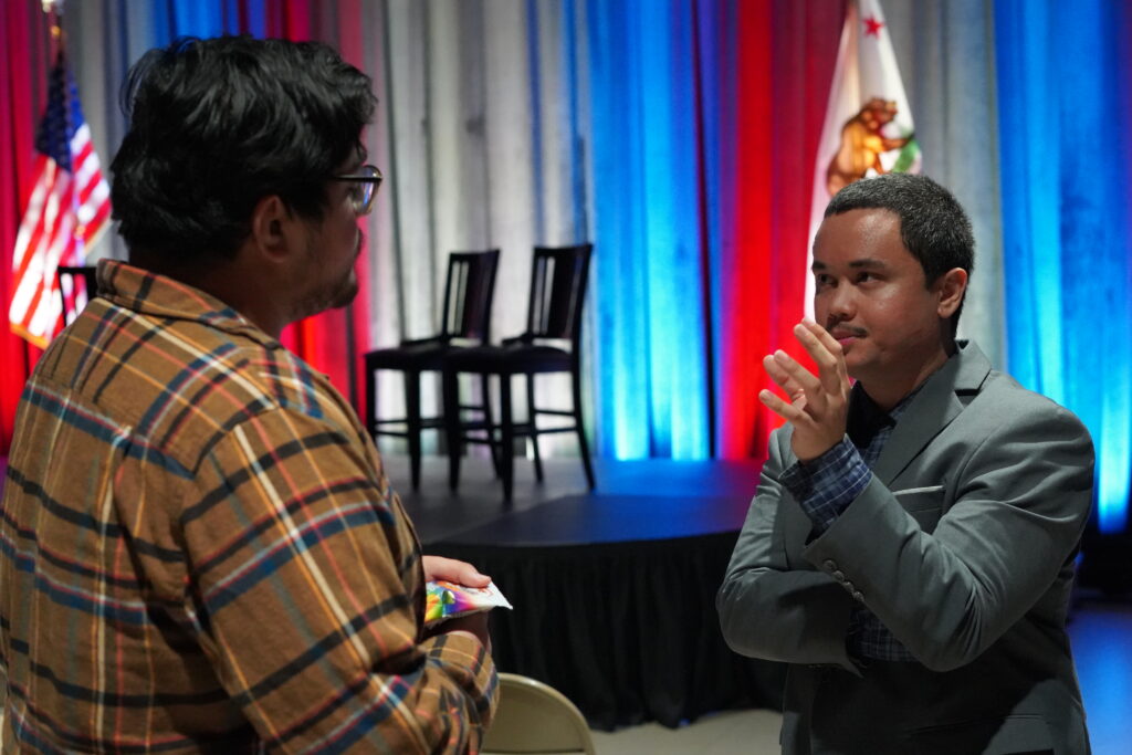 A political candidate answering questions from a voter.