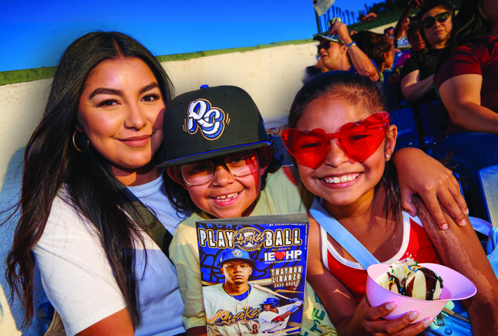 A mother and her two children at a baseball game