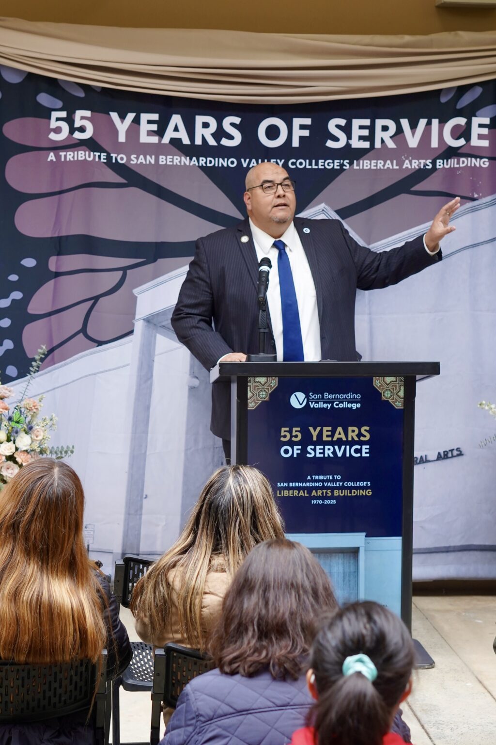 A person speaking at a podium.